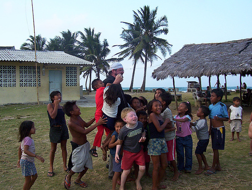 Tourist playing with Kuna children in Ogobsucun Village